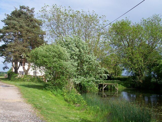 Hinton Lodge Looking directly East towards Hinton Lodge and the adjacent pond