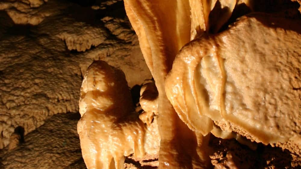A close-up of cave formations with stalactites and stalagmites.