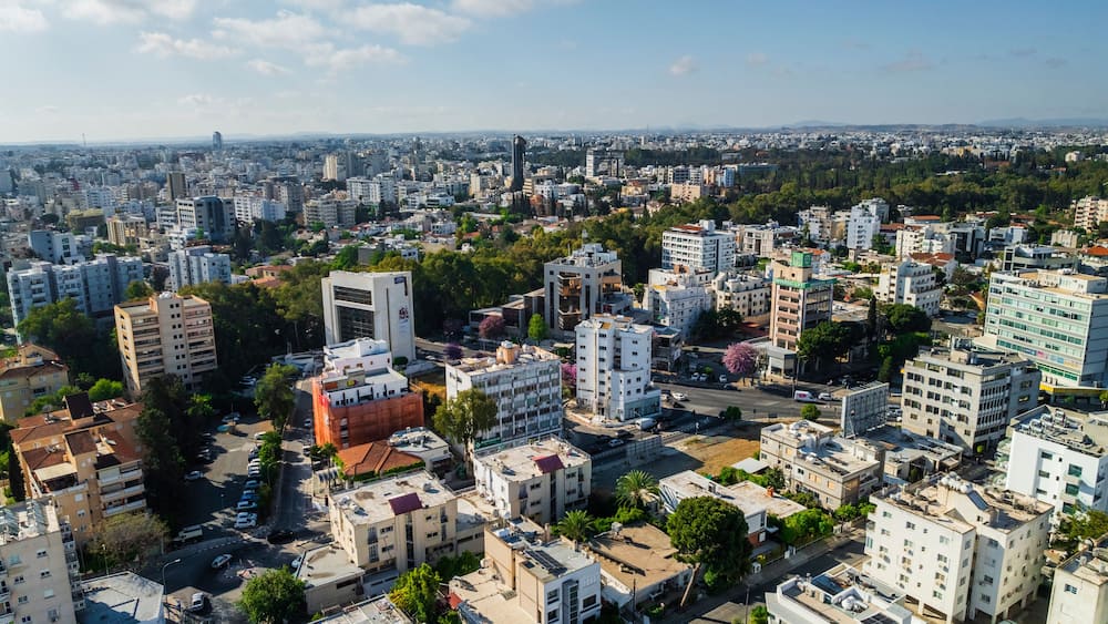 Aerial view of vibrant urban skyline with modern high-rise buildings and greenery, Egkomi Lefkosias, Nicosia, Cyprus.