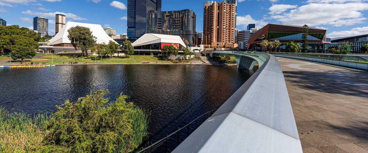 A river with modern buildings and a bridge.