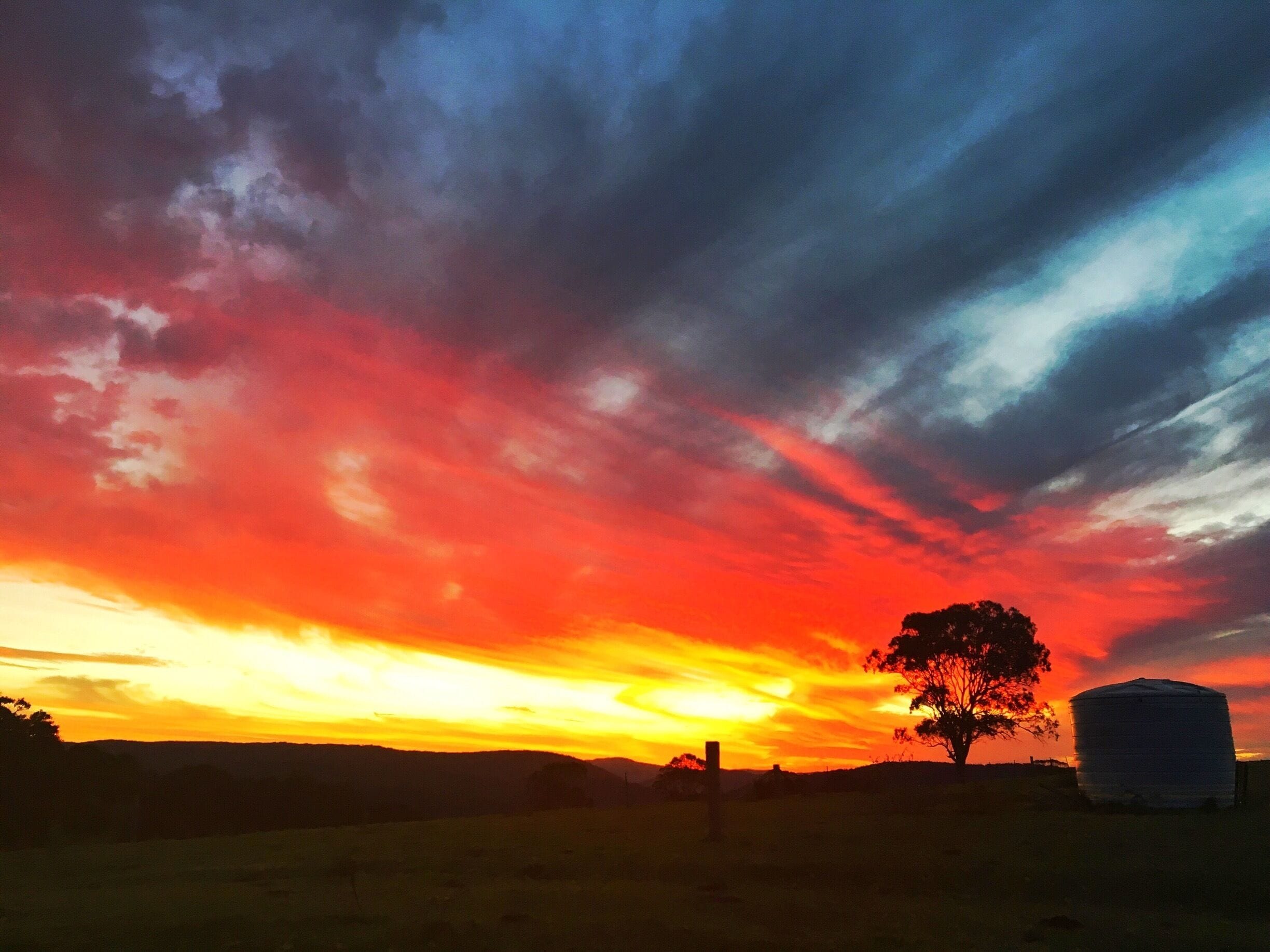 Red at night is the shepherd's delight! The sunsets at night in the Australian west are second to none. Don't limit yourself to the city, get out and start heading west. This was taken on a friend's property an hour west of the Sunshine Coast in Queensland. It just got better and better. It doesn't get more iconic that this with the water tank and lonely tree. I'd just arrived back to Australia for a two week visit. It makes me homesick just to look at it.

#red #queensland #australia #sunset