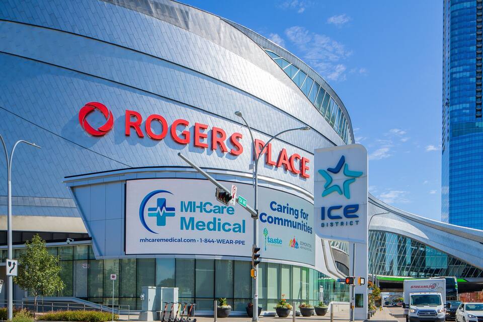 A modern building with the Rogers Place sign, a medical facility, and an Ice District sign.