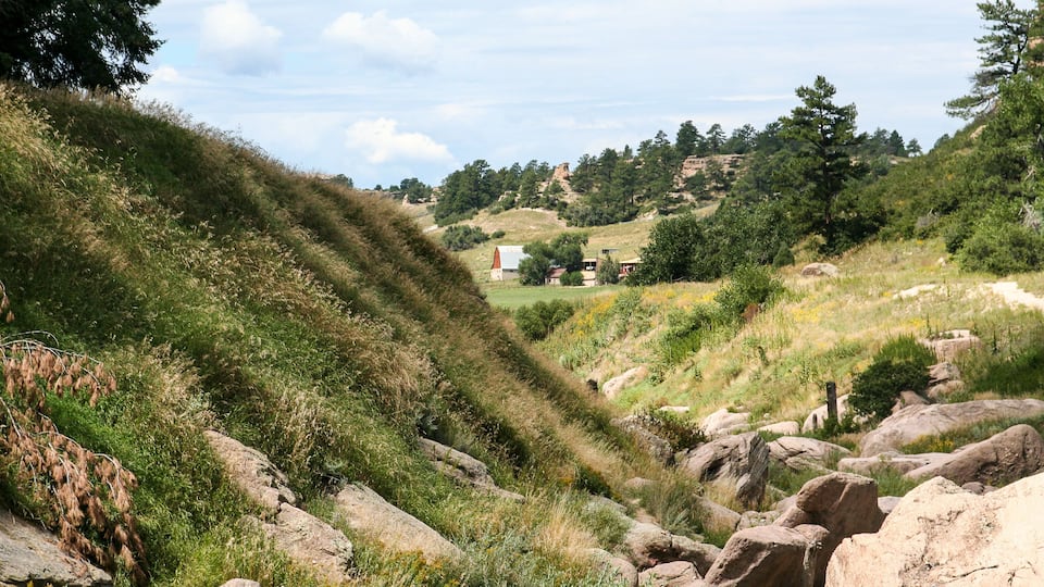 View of barn between the hills seen from the trails of Castlewood Canyon State Park