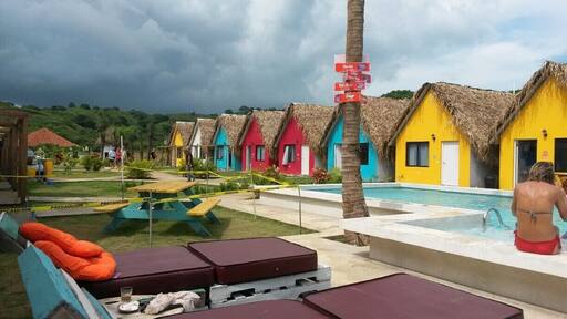 Selina Hostels at Playa Venao
The hostel is new and not finished yet, but it has a great design, is located directly at the beach and the staff is really cool. A con is that there is only one shop which has basically nothing and is really expensive; so you either have to bring your food or eat at the bar in the hostel.
The beach itself is good for surfers, but you can also enjoy the waves without a board.
There are only two (or maybe three; nobody knows) buses from Pedasí to Playa Venao: once in the morning (I think at 7) and once at 12 o'clock. It takes around 1.5 hours. Keep your eyes open and when you see the sign of the hostel, shout "(la) parada, por favor"