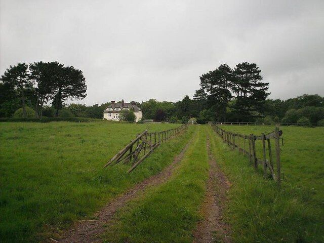 Around Ashtead Woods Road Pasture land, now occupied primarily by horses, surrounds one of a number of large houses that were built along Ashtead Woods Road in the late C19th/early C20th. The bank of trees beyond reveals the edge of Ashtead Common. Considering the location - on the northern edge of Ashtead, less than half a mile from the M25 and the border with Greater London - the scene is remarkably rural in character.