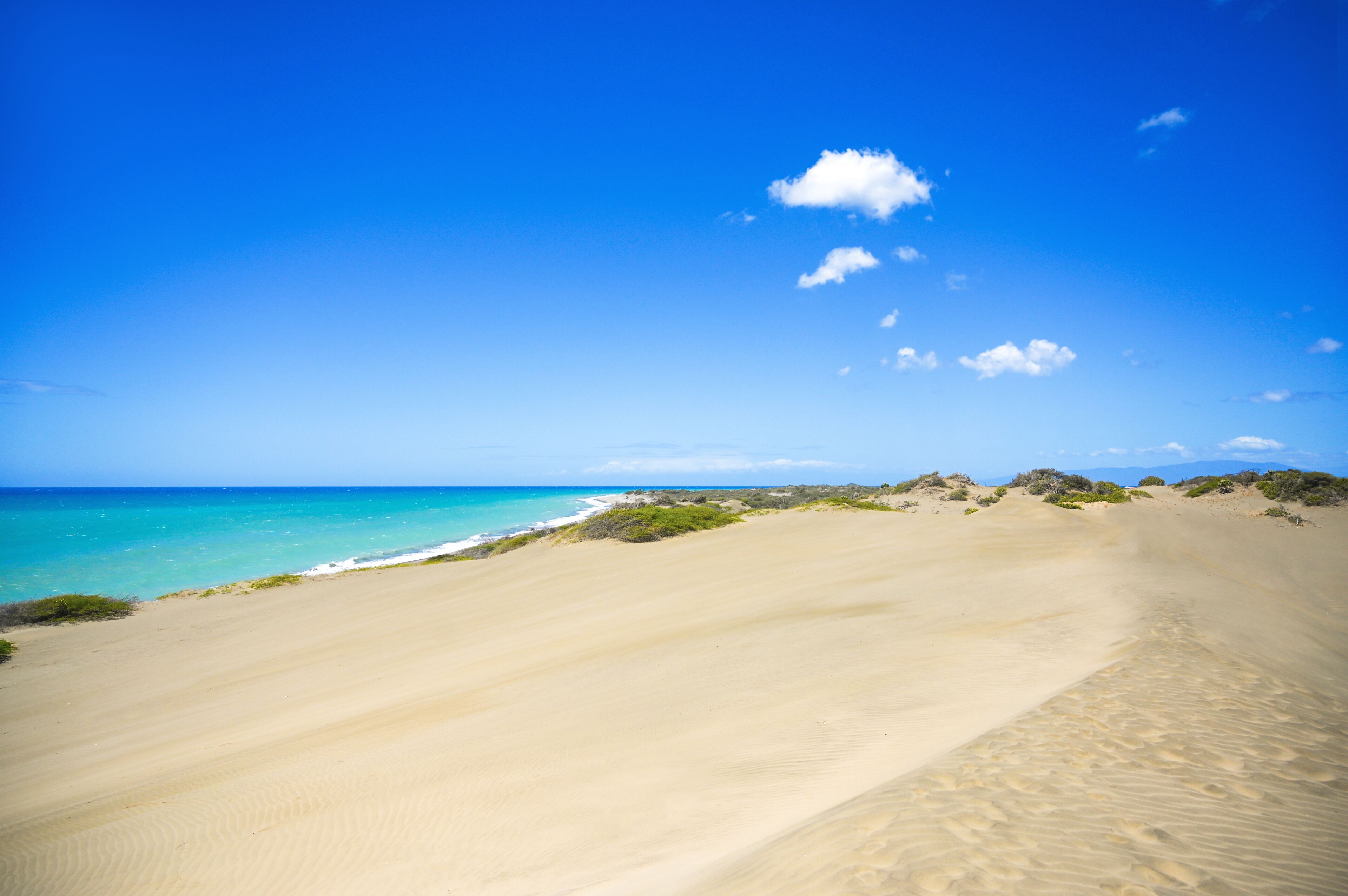 Desert landscape with sea near in Domican republic. Las Salinas, dunes. Travelling destination.