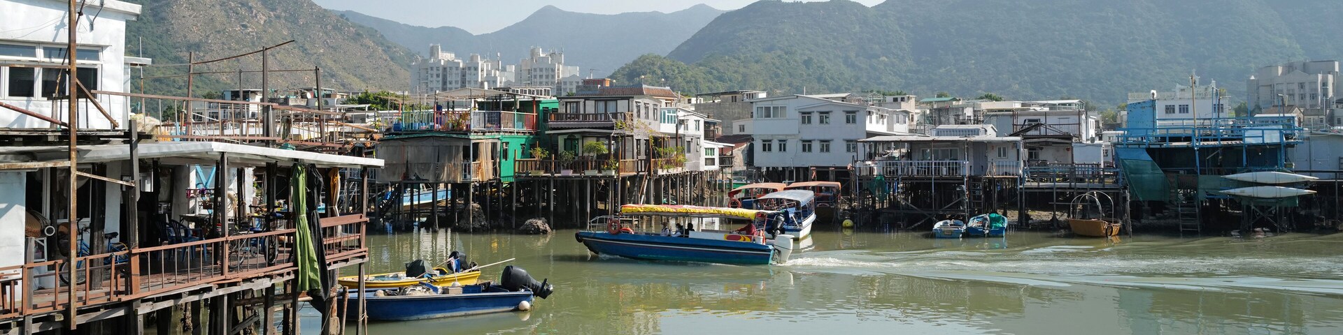 wide photography traditional Hong Kong old wooden house, boat and river in countryside