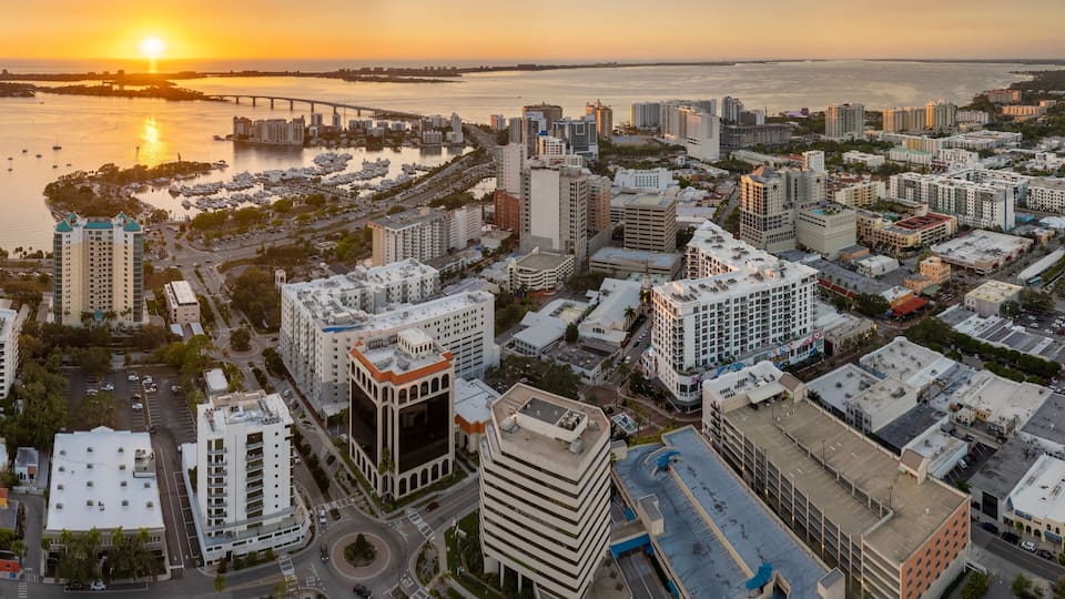 Above view of Sarasota city, Florida with waterfront office high-rise buildings and John Ringling Causeway leading from downtown to St. Armands Key. Development of housing and transportation in the US