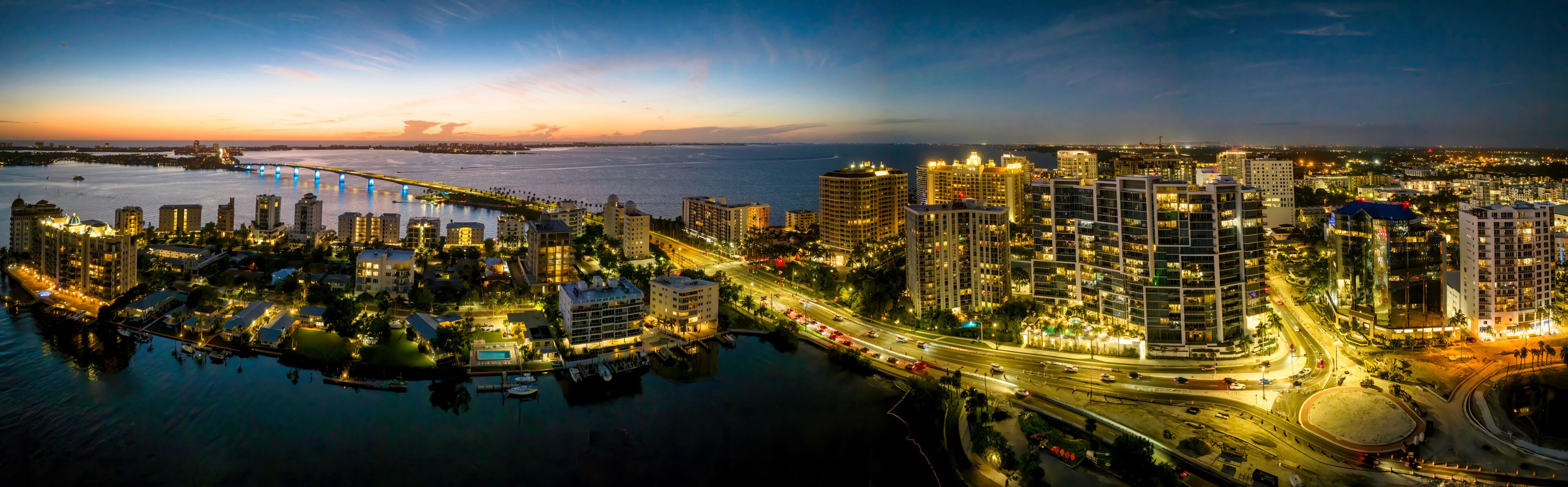 Sarasota aerial blue hour with city and Ringling bridge lit up.
