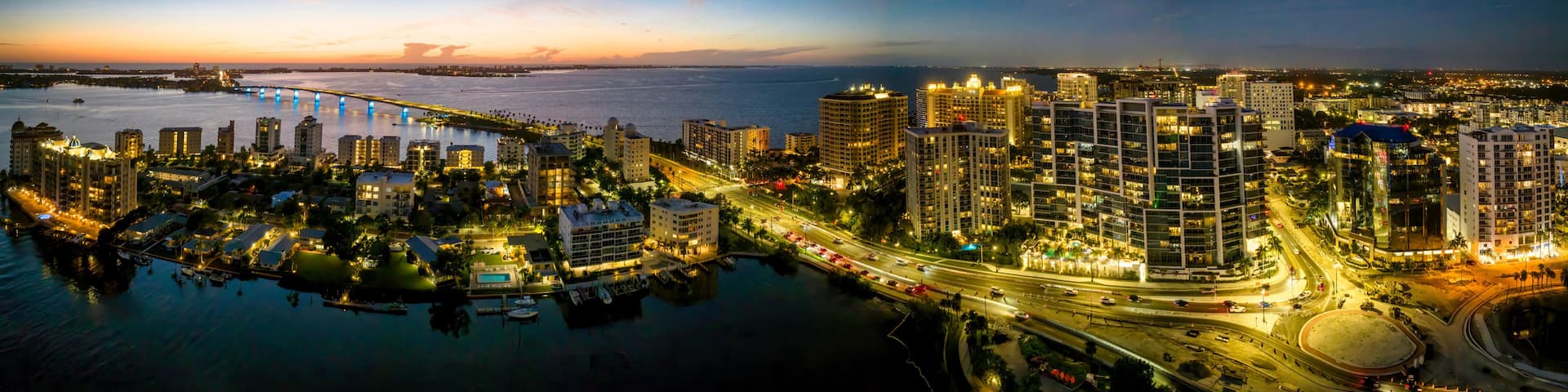 Sarasota aerial blue hour with city and Ringling bridge lit up.