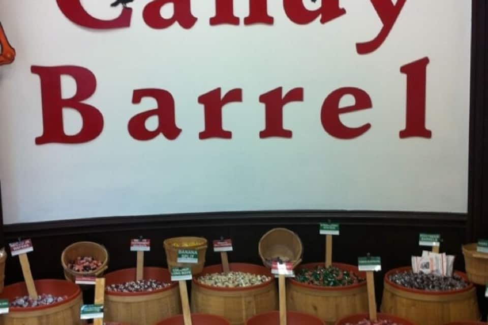 A candy barrel display with various types of candy.