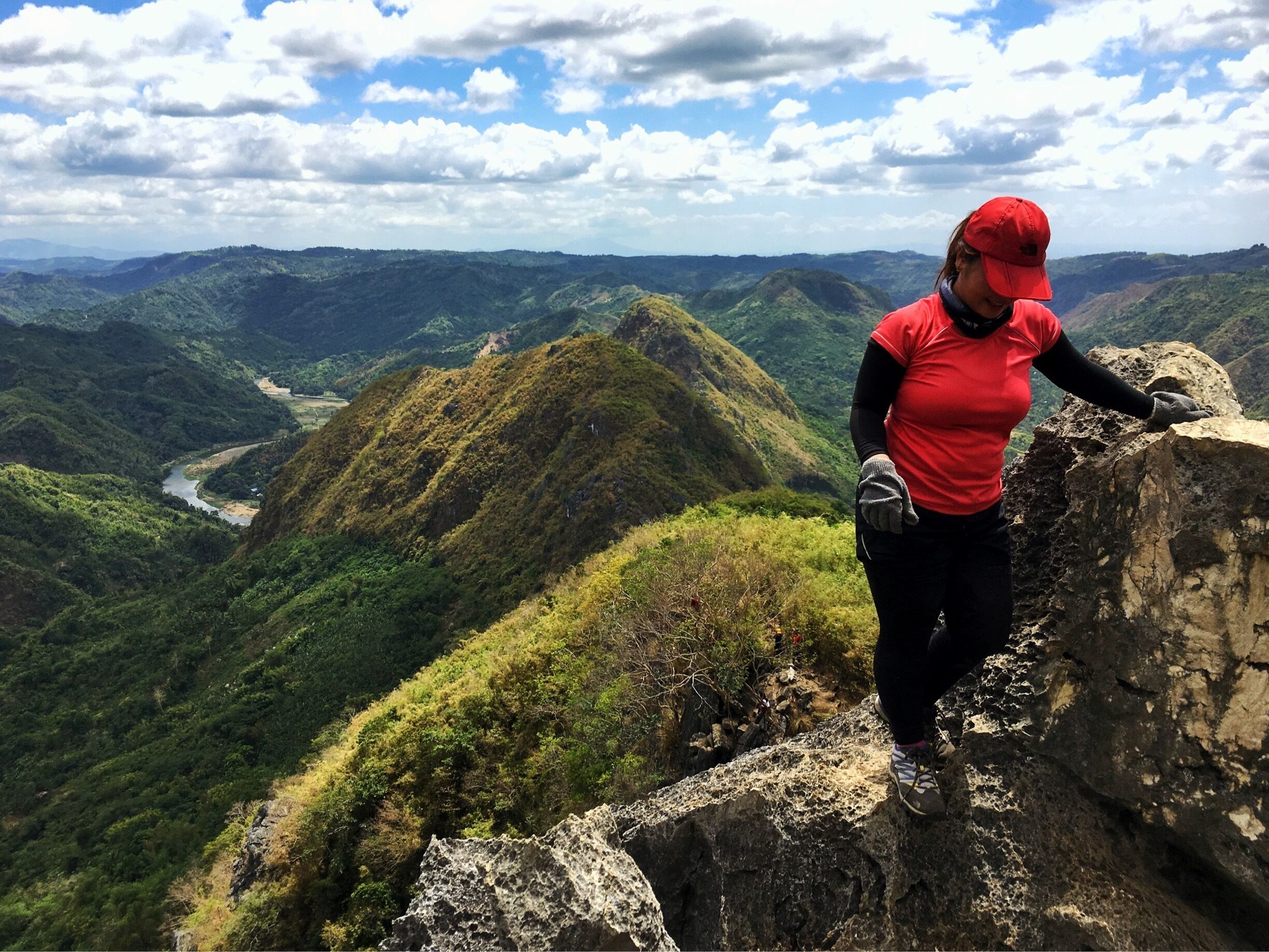 Rock climbing in the limestone cliffs of Mt. Hapunang Banoi (with the summits of Mt. Pamitinan and Mt. Binacayan in the background).