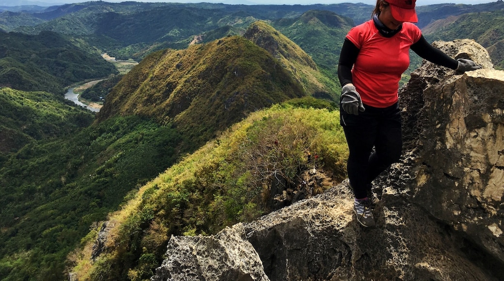 Rock climbing in the limestone cliffs of Mt. Hapunang Banoi (with the summits of Mt. Pamitinan and Mt. Binacayan in the background).