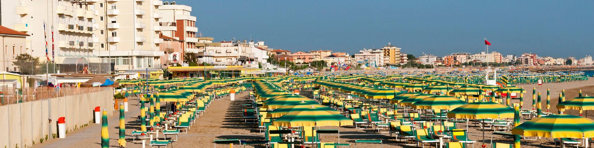 Rimini beach equipped with sun beds and umbrellas in the early morning summer