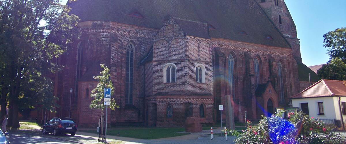 A large brick church with a prominent tower and arched windows.