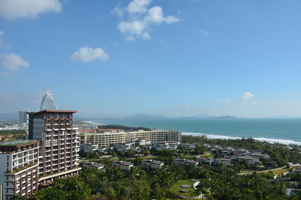 A coastal resort with multiple buildings, a prominent tower, and a view of the ocean.