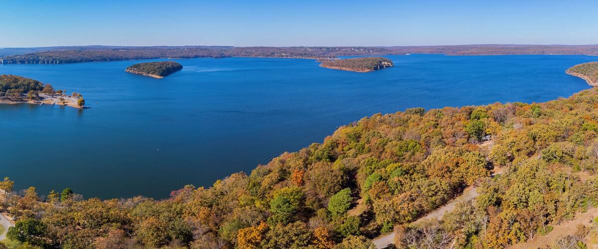 A large lake surrounded by forested hills.