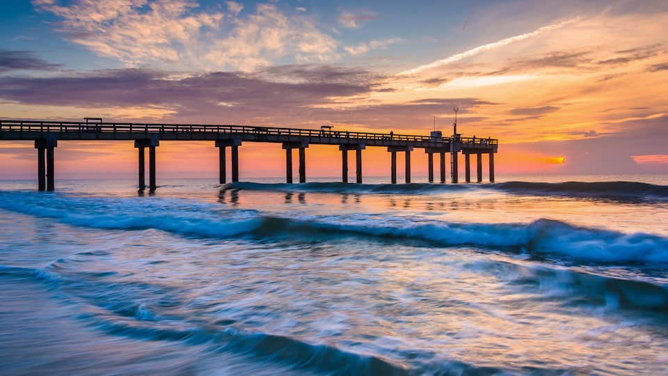 Waves on the Atlantic Ocean and fishing pier at sunrise, St. Aug