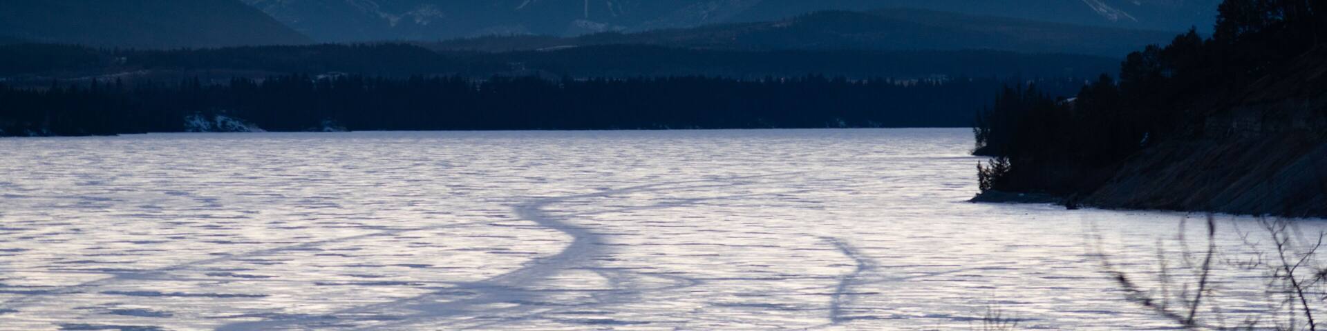 Mountains over a frozen lake at sunset