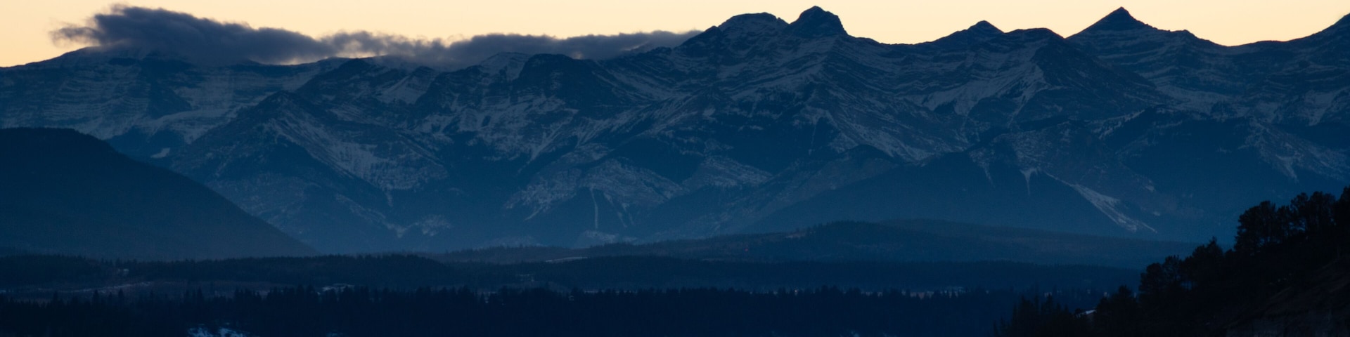 Mountains over a frozen lake at sunset
