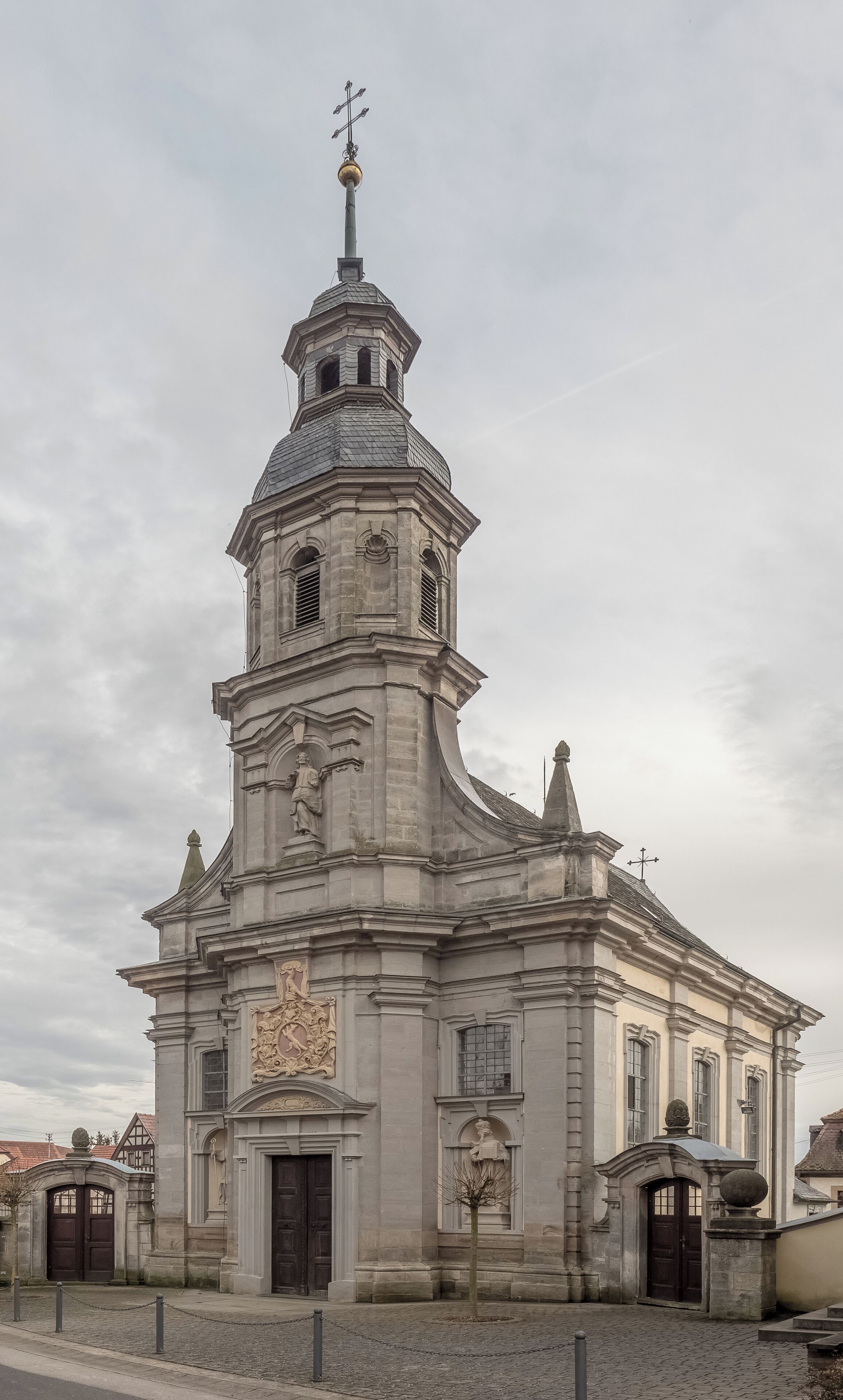 A historic church with a bell tower, ornate carvings, and a weather vane.