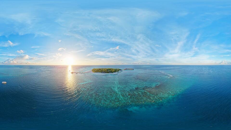 Panoramic view of Alimatha island in the Maldives, Vaavu Atoll, at sunset, with luxury over water villas. Aerial seamless 360 degree spherical panorama