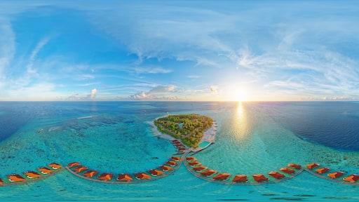 Luxurious overwater villas on Alimatha Island in the Maldives, Vaavu Atoll, at sunset. Aerial seamless 360 degree spherical panorama