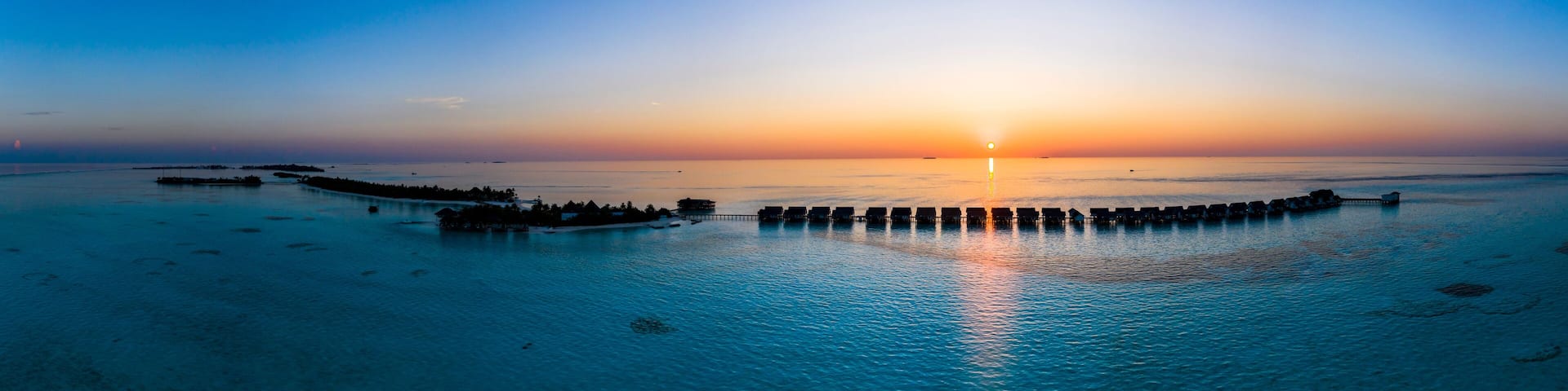 Maldives, South Male Atoll, Aerial view of lagoon of the Maldives island of Maadhoo at sunset