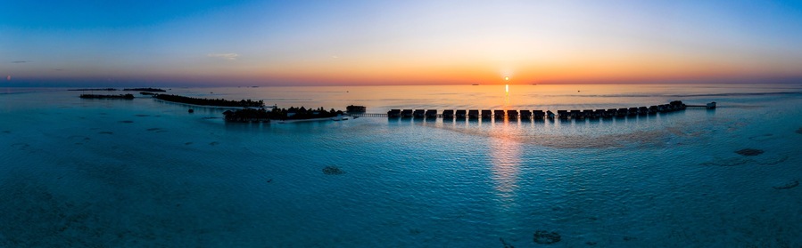 Maldives, South Male Atoll, Aerial view of lagoon of the Maldives island of Maadhoo at sunset