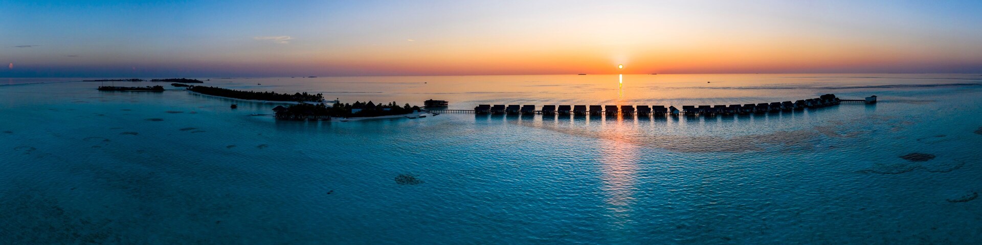 Maldives, South Male Atoll, Aerial view of lagoon of the Maldives island of Maadhoo at sunset