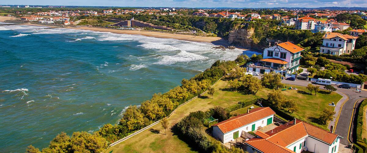 A coastal town with houses near the beach and cliffs.