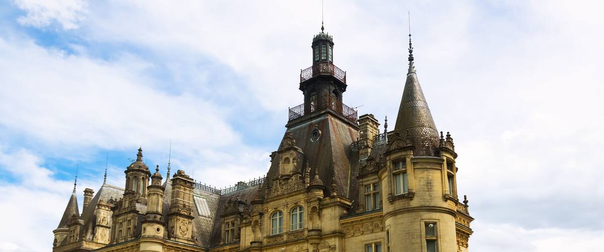 A grand, historic building with multiple towers and ornate architecture.