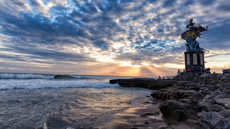 Sun sets behind a sculpture of Gajah Mina on Pererenan beach in Canggu, Bali in Indonesia. ; Shutterstock ID 664577347; Purchase Order: -