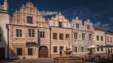 August 2017
Burgher houses, Slavonice, Czech republic
Slavonice is small town on the border of Moravia, South Bohemia and Austria. Its distance from other places preserved its medieval Renaissance city centre look through centuries to date.
Its heyday was in 14th to 16th centuries when it was an important town on the route from Prague to Vienna.
In the picture you can see two most beautiful burgher houses (Nr. 518 on the left and 517 on the right). The one on the left has actually two facades so it looks like there are three houses. They have been Gothic originally but were rebuilt in 1559 in distinguished Renaissance style. All of them have exquisite facades decorated with Sgrafitto paintings and an oriel. The houses are situated on the Upper square opposit a baroque fountain of Saint Florian built in 1783.