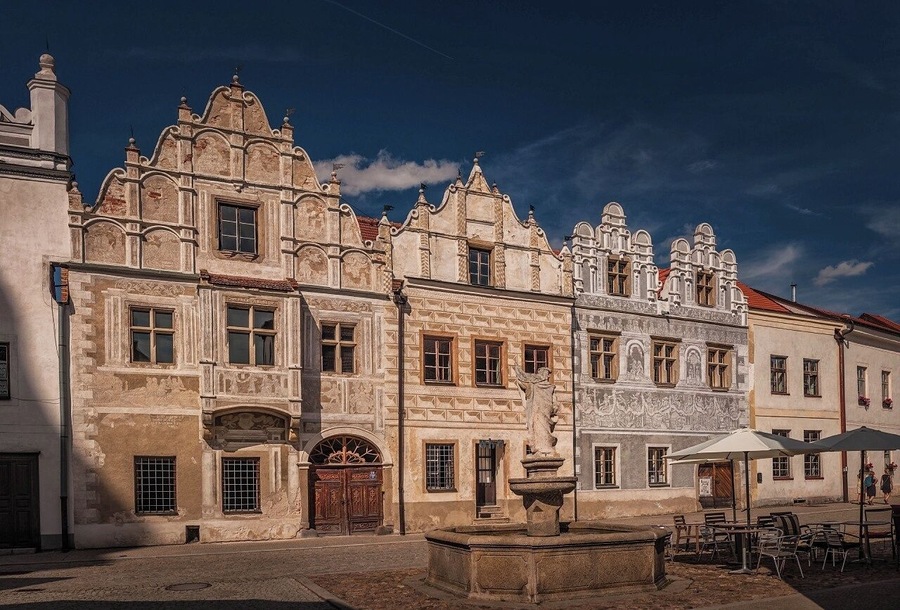 August 2017
Burgher houses, Slavonice, Czech republic
Slavonice is small town on the border of Moravia, South Bohemia and Austria. Its distance from other places preserved its medieval Renaissance city centre look through centuries to date.
Its heyday was in 14th to 16th centuries when it was an important town on the route from Prague to Vienna. 
In the picture you can see two most beautiful burgher houses    (Nr. 518 on the left and 517 on the right). The one on the left has actually two facades so it looks like there are three houses. They have been Gothic originally but were rebuilt in 1559 in distinguished Renaissance style. All of them have exquisite  facades decorated with Sgrafitto paintings and an oriel. The houses are situated on the Upper square opposit a baroque fountain of Saint Florian built in 1783.