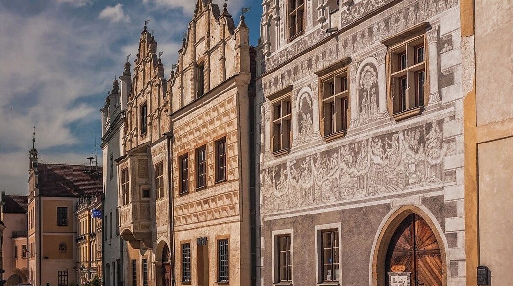 August 2017
Burgher houses, Slavonice, Czech republic
Slavonice is small town on the border of Moravia, South Bohemia and Austria. Its distance from other places preserved its medieval Renaissance city centre look through centuries to date.
Its heyday was in 14th to 16th centuries when it was an important town on the route from Prague to Vienna.
In the picture you can see two most beautiful burgher houses (Nr. 518 on the left and 517 on the right). The one on the left has actually two facades so it looks like there are three houses. They have been Gothic originally but were rebuilt in 1559 in distinguished Renaissance style. All of them have exquisite facades decorated with Sgrafitto paintings and an oriel. The houses are situated on the Upper square opposit a baroque fountain of Saint Florian built in 1783.