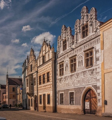 August 2017
Burgher houses, Slavonice, Czech republic
Slavonice is small town on the border of Moravia, South Bohemia and Austria. Its distance from other places preserved its medieval Renaissance city centre look through centuries to date.
Its heyday was in 14th to 16th centuries when it was an important town on the route from Prague to Vienna.
In the picture you can see two most beautiful burgher houses (Nr. 518 on the left and 517 on the right). The one on the left has actually two facades so it looks like there are three houses. They have been Gothic originally but were rebuilt in 1559 in distinguished Renaissance style. All of them have exquisite facades decorated with Sgrafitto paintings and an oriel. The houses are situated on the Upper square opposit a baroque fountain of Saint Florian built in 1783.
