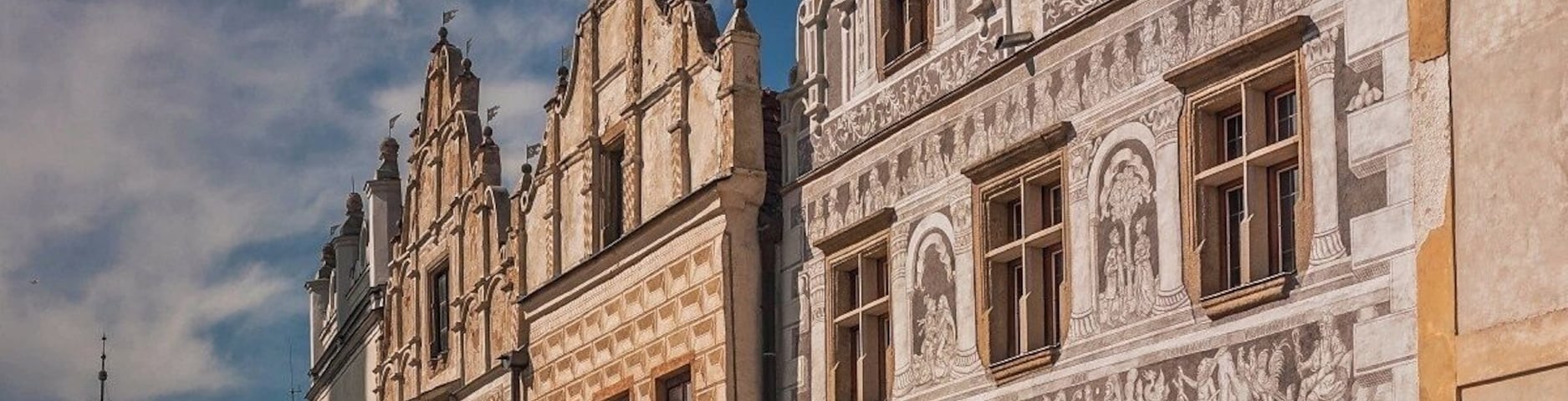 August 2017
Burgher houses, Slavonice, Czech republic
Slavonice is small town on the border of Moravia, South Bohemia and Austria. Its distance from other places preserved its medieval Renaissance city centre look through centuries to date.
Its heyday was in 14th to 16th centuries when it was an important town on the route from Prague to Vienna.
In the picture you can see two most beautiful burgher houses (Nr. 518 on the left and 517 on the right). The one on the left has actually two facades so it looks like there are three houses. They have been Gothic originally but were rebuilt in 1559 in distinguished Renaissance style. All of them have exquisite facades decorated with Sgrafitto paintings and an oriel. The houses are situated on the Upper square opposit a baroque fountain of Saint Florian built in 1783.