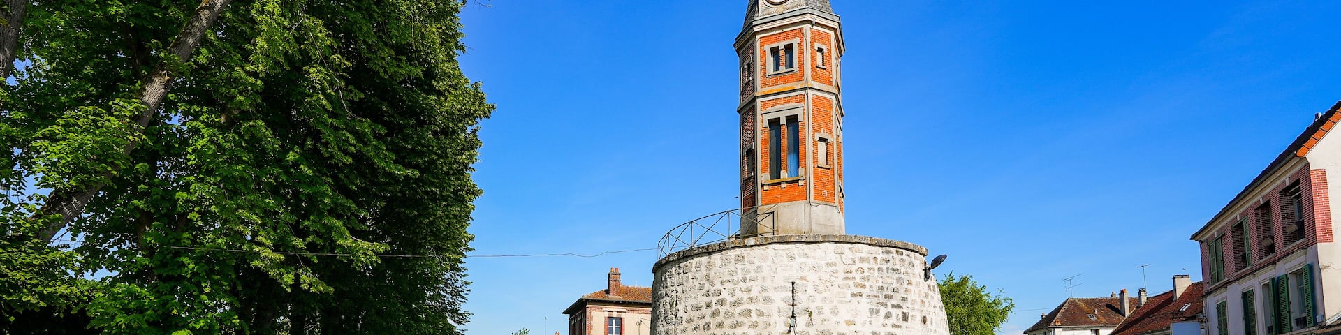Brick belfry built over the ruins of a medieval fortification tower by the Grand Morin river in Crécy la Chapelle, a village of Seine et Marne in Paris region (France) nicknamed "Venice of Brie"