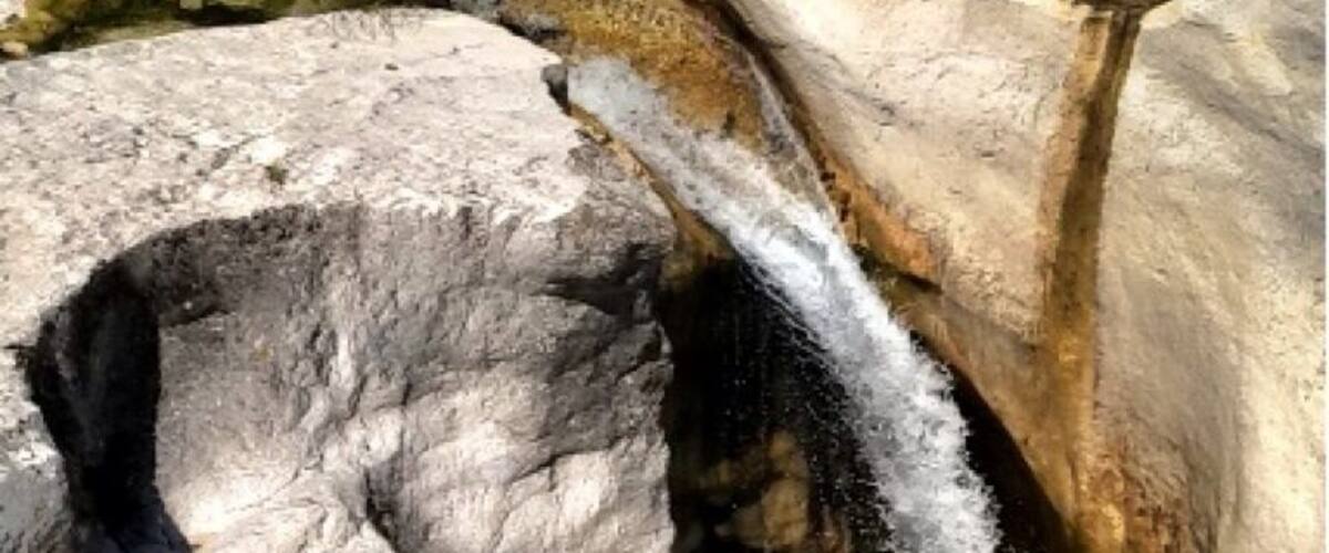 A waterfall cascading through a rocky gorge.
