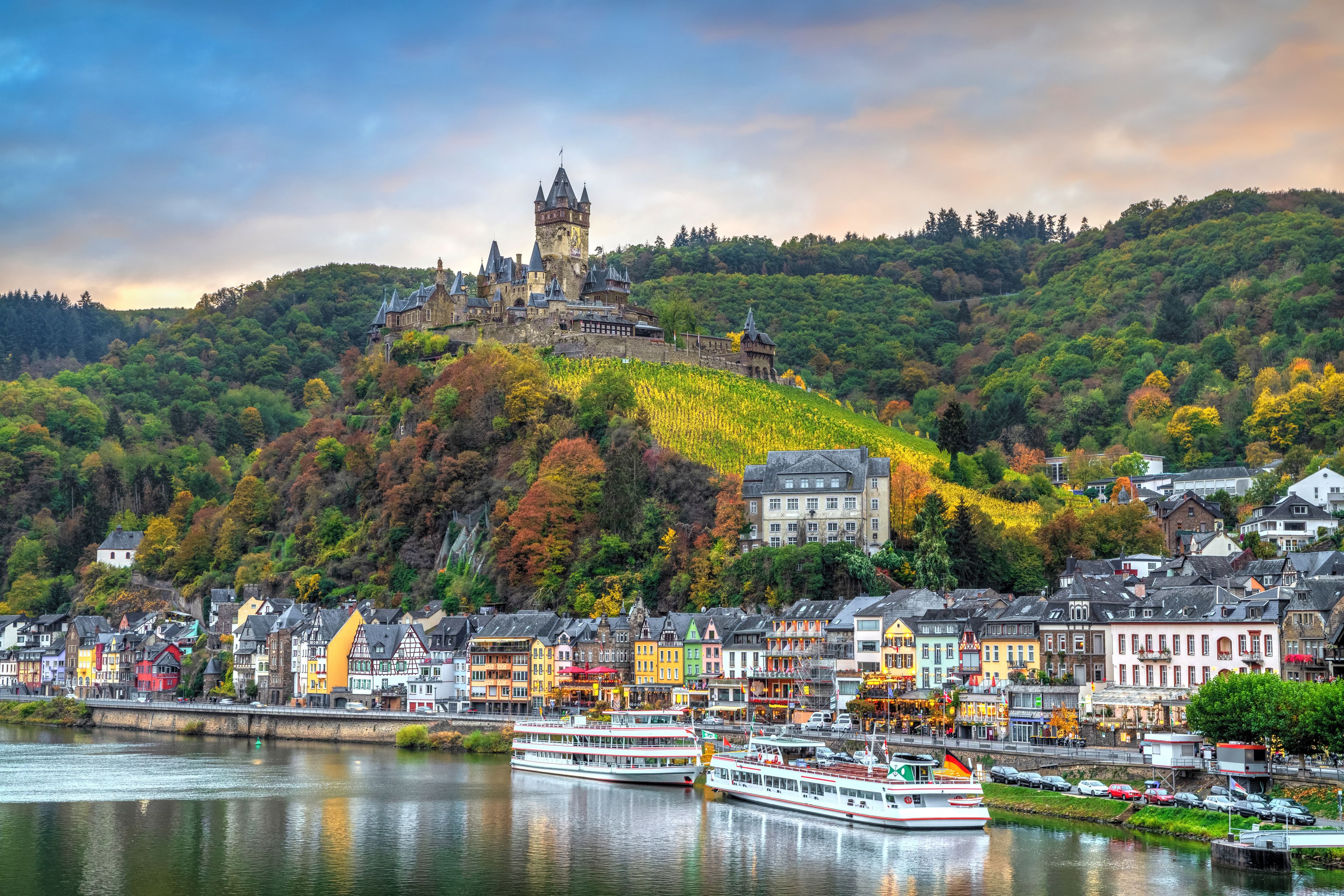 Cochem in autumn, Germany. Cityscape with Moselle river, colorful houses on embankment and Cochem Castle
