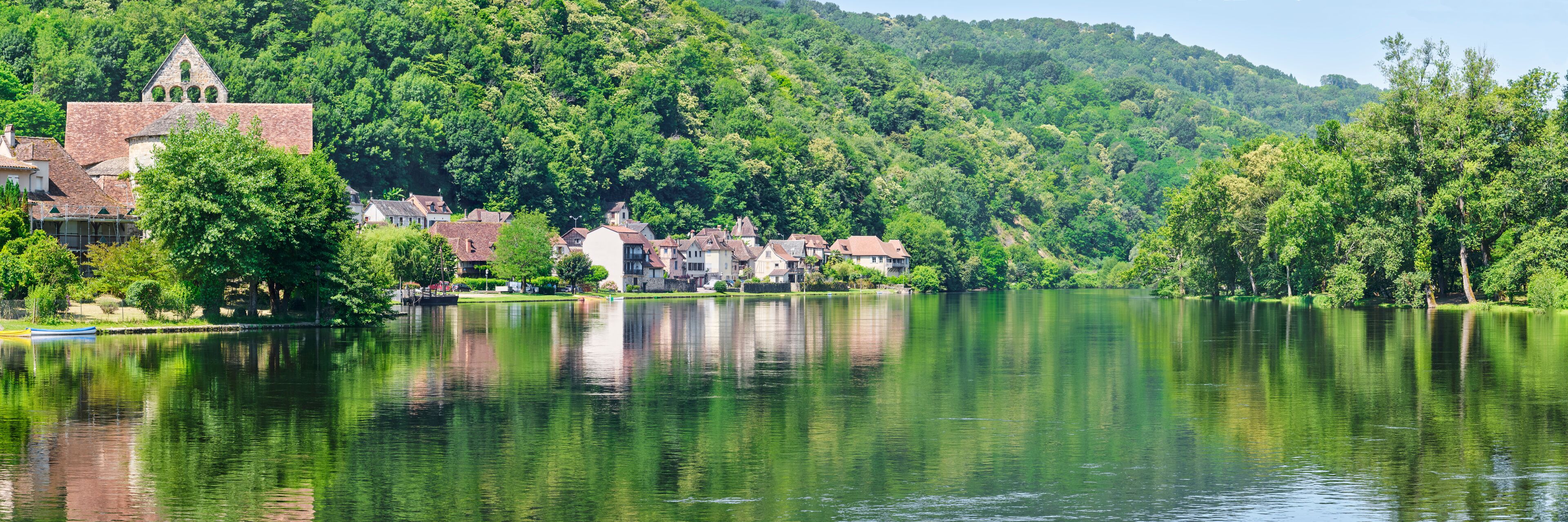 Panorama of the village of Beaulieu-sur-Dordogne and the Dordogne river in Corrèze Nouvelle-Aquitaine in Southern France on a sunny day in summer	