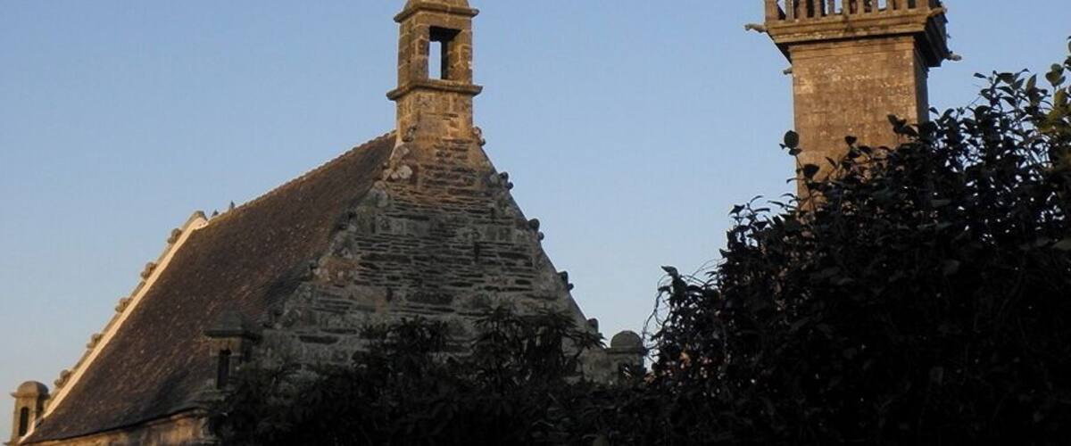 A church with a tall bell tower and a smaller steeple.