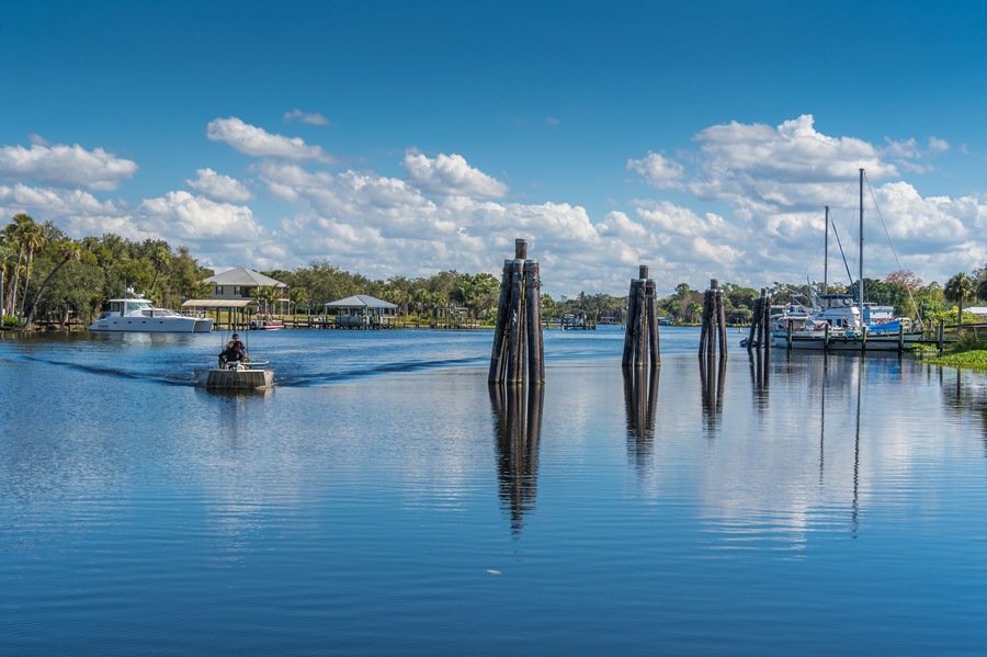 Boat on River by Piers