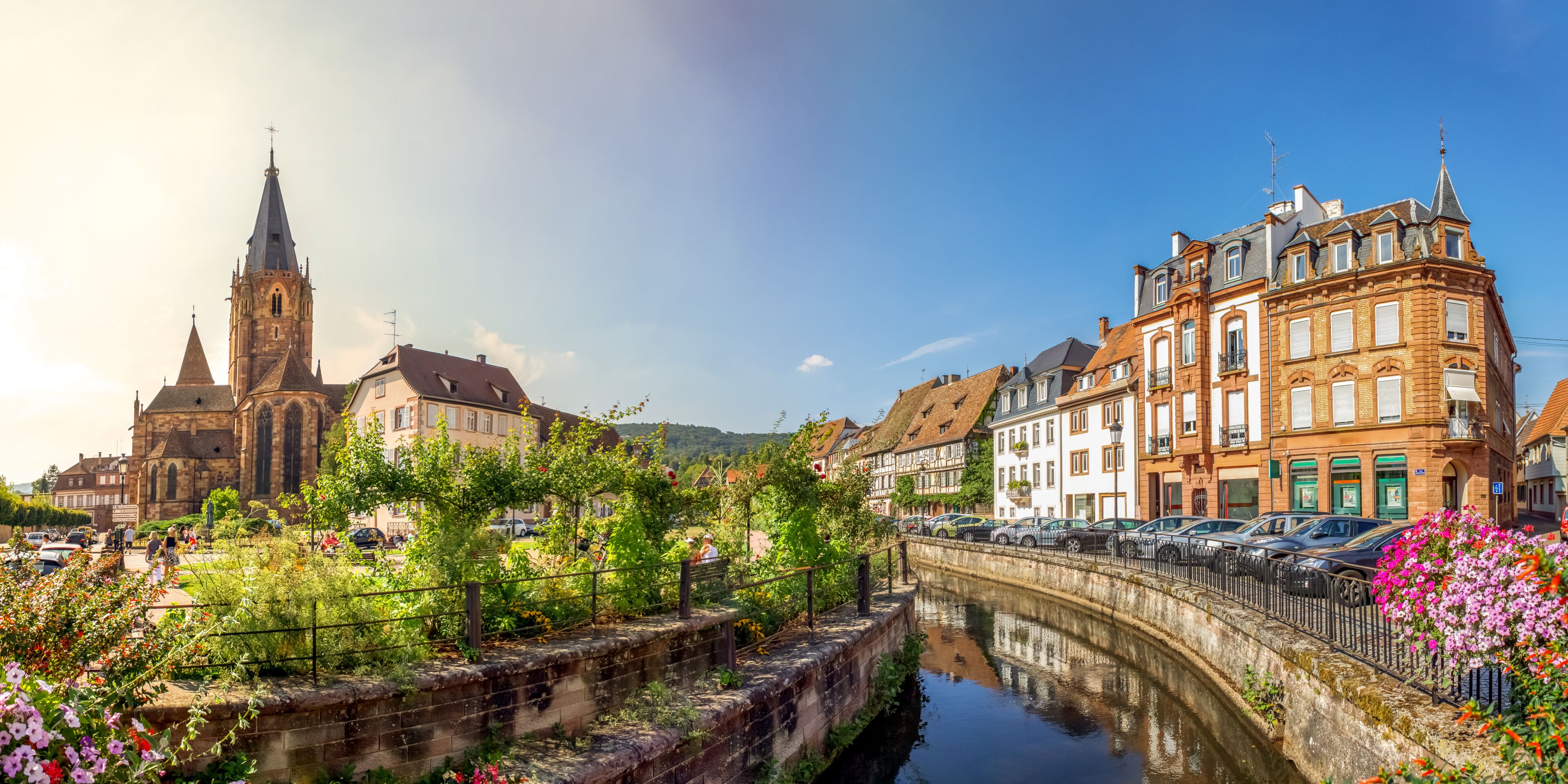A historic town with a church, a canal, and traditional European architecture.