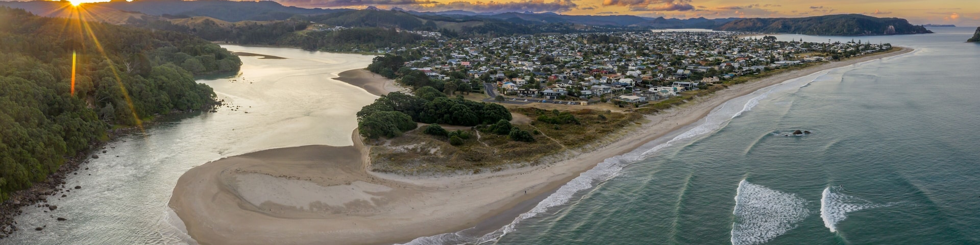 Sunrise over Whangamata town, beach, and estuary. Tranquil morning scene. ,, Coromandel Peninsula, New Zealand