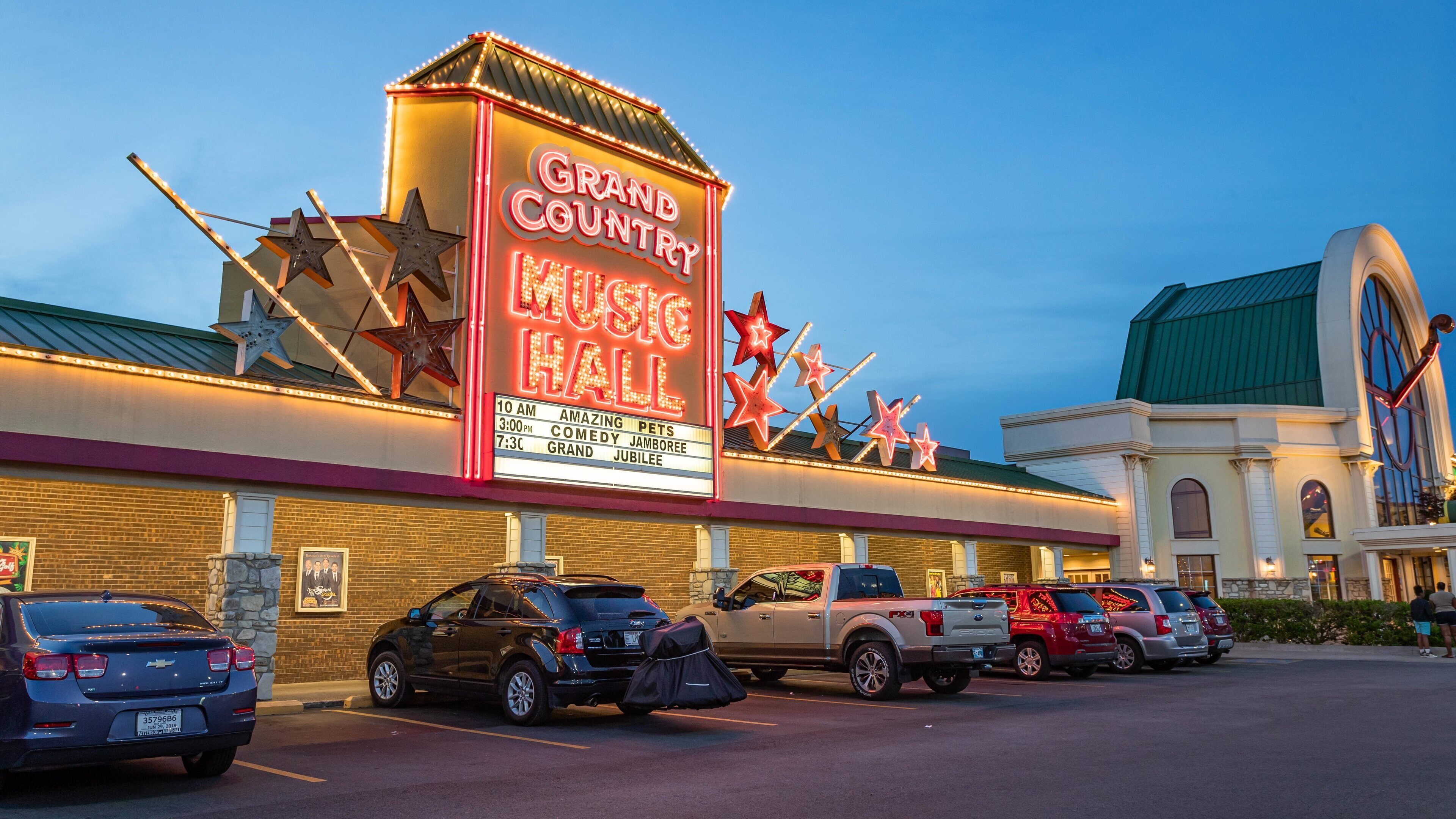 Grand Country Music Hall featuring night scenes and signage