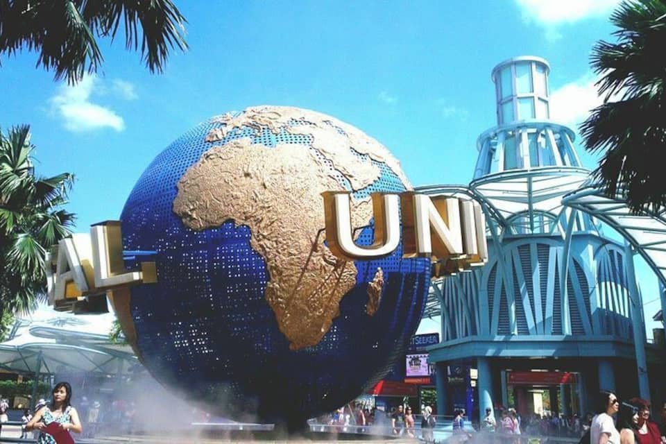 A large globe with 'UNL' text, palm trees, and a futuristic building.