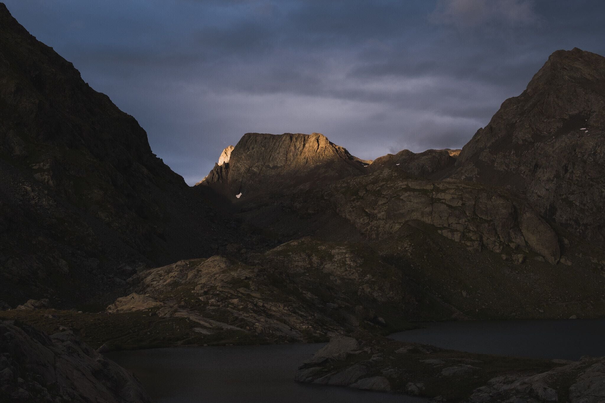 500px provided description: The last touch of sun hitting the peak. [#sunset ,#mountains ,#travel ,#mountain ,#valley ,#cliff ,#peak ,#hill ,#scenic ,#rocky ,#hillside ,#montain ,#mountain lake ,#alpine lake ,#mountainscape]