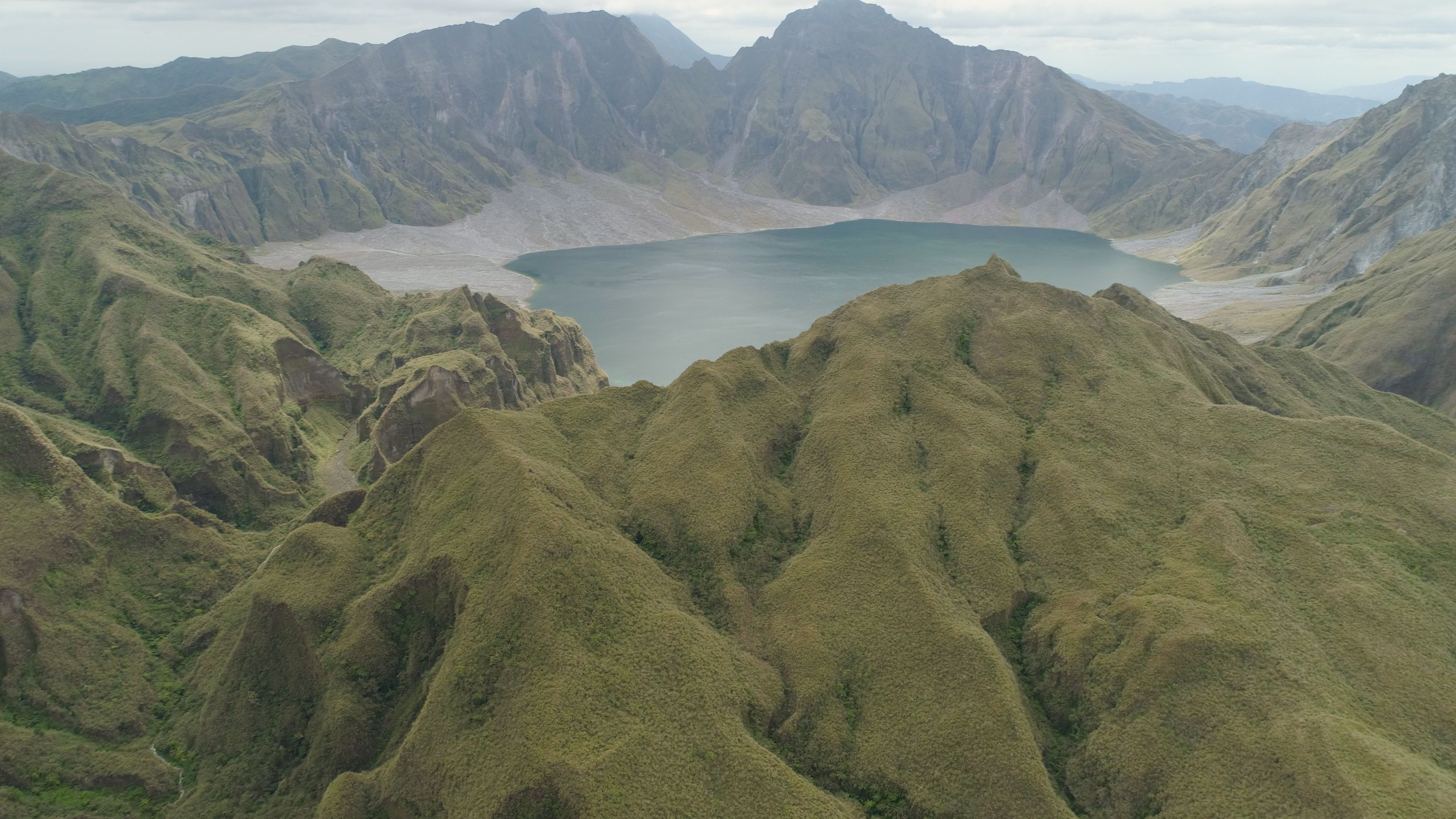 Crater lake of the volcano Pinatubo among the mountains, Philippines, Luzon. Aerial view beautiful landscape at Pinatubo mountain crater lake. Travel concept